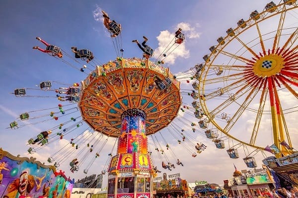 Swings, ferris wheel and other rides at a state fair