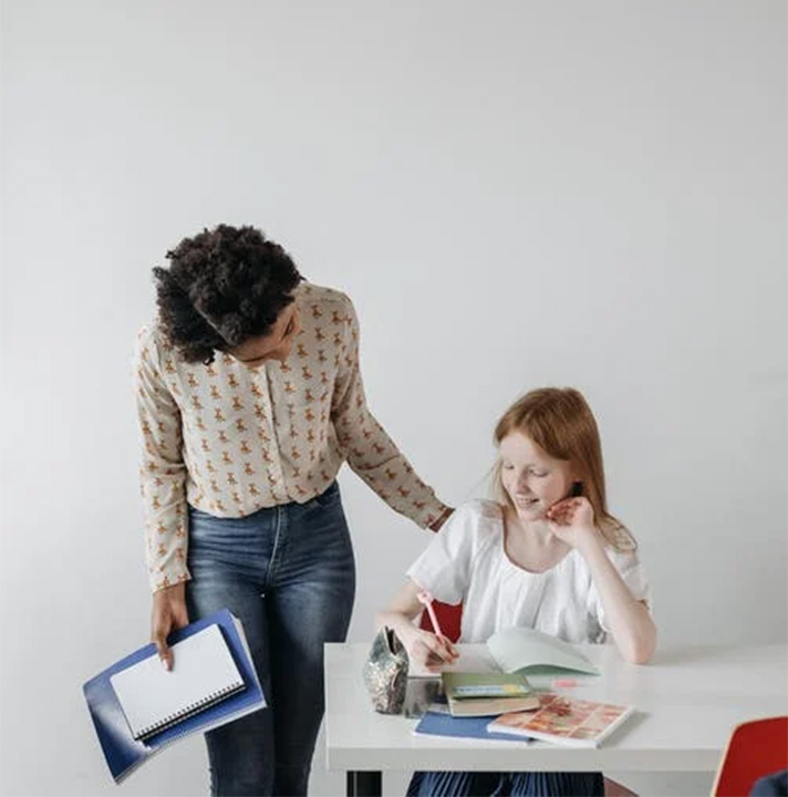 a teacher counselor writing at the desk